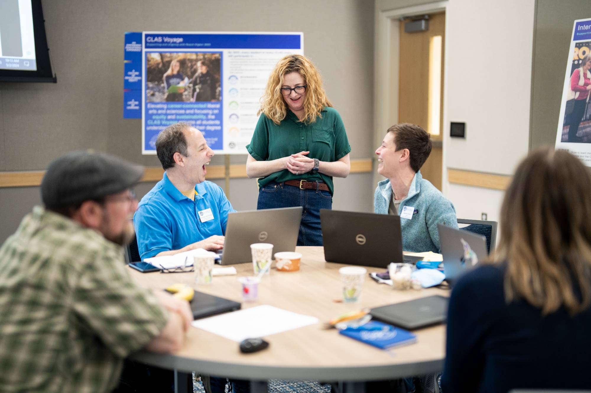 The CLAS Voyage Curriculum Director, Rachel Campbell, talks with faculty members.